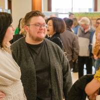 Communications students Bryce and Y talking to Taylor (left)